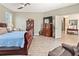 Spacious main bedroom featuring wood-look tile flooring, a ceiling fan and an ensuite bathroom at 3187 Bellflower Way, Lakeland, FL 33811