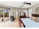Spacious main bedroom featuring wood-look tile flooring and private access to an outdoor patio at 3187 Bellflower Way, Lakeland, FL 33811