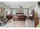 Spacious main bedroom with wood-look tile flooring, ceiling fan, and large windows with plantation shutters at 3187 Bellflower Way, Lakeland, FL 33811