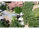 Aerial view of home nestled among mature trees, featuring a walkway from the driveway to the front entry at 319 Shadow Moss Ct # 319, Lakeland, FL 33813