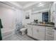 Well-lit bathroom with updated vanity, granite countertop, and shower-tub combination with modern shower curtain at 319 Shadow Moss Ct # 319, Lakeland, FL 33813