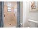 Well-lit bathroom with tiled shower and seashell-themed art at 319 Shadow Moss Ct # 319, Lakeland, FL 33813