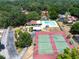 Aerial view showcasing community pool, tennis courts and proximity to residences at 319 Shadow Moss Ct # 319, Lakeland, FL 33813