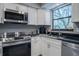 Well-lit kitchen boasts stainless steel appliances, granite countertops, and white cabinetry at 319 Shadow Moss Ct # 319, Lakeland, FL 33813