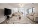 Inviting living room featuring laminate floors, comfortable furniture, and large windows offering plenty of natural light at 319 Shadow Moss Ct # 319, Lakeland, FL 33813