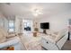 Bright living room with comfortable seating, a ceiling fan, and sliding doors leading to a cozy home office at 319 Shadow Moss Ct # 319, Lakeland, FL 33813