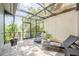 Relaxing screened patio with brick flooring and comfortable chaise lounge seating at 319 Shadow Moss Ct # 319, Lakeland, FL 33813