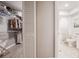 Walk-in closet adjacent to a bathroom with plenty of storage space at 319 Shadow Moss Ct # 319, Lakeland, FL 33813