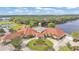 Aerial view of community clubhouse with pool, gazebo, and surrounding greenspace and water at 3252 Bellflower Way, Lakeland, FL 33811
