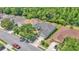 Aerial view of homes showcasing manicured lawns, mature trees and driveway parking at 3252 Bellflower Way, Lakeland, FL 33811