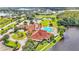 Aerial view of community clubhouse with pool, gazebo, tennis courts, lake, and surrounding community at 3252 Bellflower Way, Lakeland, FL 33811