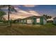 Backyard featuring a well-maintained lawn, mature trees, and screened-in porch providing a serene outdoor space at 3252 Bellflower Way, Lakeland, FL 33811