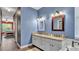 Bathroom boasts a double vanity with granite counters, soaking tub, and wood-look floors at 3252 Bellflower Way, Lakeland, FL 33811