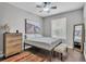 Neutral bedroom featuring a queen bed, ceiling fan, and hardwood floors at 3252 Bellflower Way, Lakeland, FL 33811