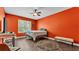 Cozy bedroom with orange walls, wood flooring, and a ceiling fan for added comfort at 3252 Bellflower Way, Lakeland, FL 33811