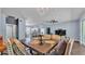 Open-concept dining room with chandelier and view into the kitchen and living room at 3252 Bellflower Way, Lakeland, FL 33811