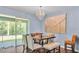 Cozy dining area featuring a chandelier, stylish furnishings, and sliding glass door to patio at 3252 Bellflower Way, Lakeland, FL 33811