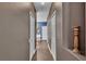 Hallway featuring wood floors and neutral walls leading to bedrooms and bathrooms at 3252 Bellflower Way, Lakeland, FL 33811