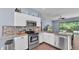 Modern kitchen features stainless steel appliances, granite counters and breakfast bar at 3252 Bellflower Way, Lakeland, FL 33811