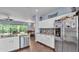 Bright kitchen with stainless appliances, and granite counters, opening to dining area at 3252 Bellflower Way, Lakeland, FL 33811