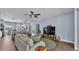 Comfortable living room featuring a ceiling fan, wood floors, and modern decor at 3252 Bellflower Way, Lakeland, FL 33811