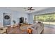 Comfortable living room featuring luxury vinyl floors, lots of seating, and a ceiling fan at 3252 Bellflower Way, Lakeland, FL 33811