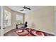Bright office featuring a ceiling fan, desk, and large windows with blinds at 3252 Bellflower Way, Lakeland, FL 33811