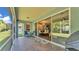 Relaxing screened patio with outdoor seating and view to chandelier-lit dining area through sliding glass doors at 3252 Bellflower Way, Lakeland, FL 33811