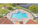Aerial image showing the community pool and hot tub with ample seating, gazebo, and beautiful waterfront at 3252 Bellflower Way, Lakeland, FL 33811