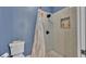 Modern shower with white tiled walls and a built-in shelf at 3252 Bellflower Way, Lakeland, FL 33811