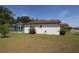White home with a screened in pool and a manicured green lawn at 3359 Sanoma Dr, Lakeland, FL 33811