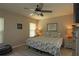 Comfortable bedroom featuring a ceiling fan, a plush bed with stylish bedding, and ample natural light at 3359 Sanoma Dr, Lakeland, FL 33811