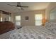 Well-lit bedroom featuring a comfortable bed, a large dresser, and a ceiling fan at 3359 Sanoma Dr, Lakeland, FL 33811