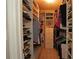 Well-organized walk-in closet offering abundant storage with custom shelving for shoes, clothing, and accessories at 3359 Sanoma Dr, Lakeland, FL 33811