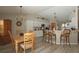 Well-lit dining area adjacent to the kitchen, with a wooden table set, bar stools, and ample space for entertaining at 3359 Sanoma Dr, Lakeland, FL 33811