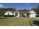 Charming single-story home with lush landscaping, a well-manicured lawn, and a two-car garage at 3359 Sanoma Dr, Lakeland, FL 33811