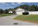Single-story home with a two-car garage and manicured lawn, showcasing its curb appeal and driveway at 3359 Sanoma Dr, Lakeland, FL 33811