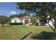 Charming single-story home with lush landscaping and a well-manicured lawn, partially shaded by a tree at 3359 Sanoma Dr, Lakeland, FL 33811