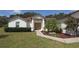 Charming single-story home with a well-manicured lawn, mature landscaping, and a welcoming double-door entrance at 3359 Sanoma Dr, Lakeland, FL 33811