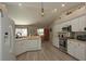 Bright kitchen featuring white cabinets, modern appliances, wood look flooring, and an adjacent dining area at 3359 Sanoma Dr, Lakeland, FL 33811