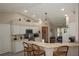 Well-lit kitchen boasts white cabinets, stainless steel appliances, wood look flooring, and a breakfast bar at 3359 Sanoma Dr, Lakeland, FL 33811