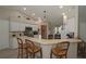 Open kitchen with white cabinets, modern appliances, breakfast bar, and wood-look flooring at 3359 Sanoma Dr, Lakeland, FL 33811