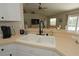Close-up of the kitchen sink area, showcasing ample counter space and a view into the living area at 3359 Sanoma Dr, Lakeland, FL 33811