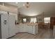 Spacious kitchen with white cabinets, wood look flooring, and updated appliances, open to the dining area at 3359 Sanoma Dr, Lakeland, FL 33811