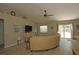 Comfortable living room with stylish furnishings, a ceiling fan, wood-look floors, and easy access to the outdoor pool area at 3359 Sanoma Dr, Lakeland, FL 33811