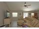 Cozy living room featuring a comfortable seating arrangement, wood-look flooring, and access to the dining area at 3359 Sanoma Dr, Lakeland, FL 33811
