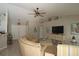 Inviting living room with a comfortable curved couch, neutral decor, ceiling fan, and plenty of natural light at 3359 Sanoma Dr, Lakeland, FL 33811