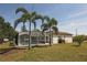 A screened-in pool surrounded by palm trees enhances this property's outdoor charm at 3359 Sanoma Dr, Lakeland, FL 33811