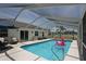Enjoy the screened-in pool with a fun flamingo float and plenty of space for relaxing and entertaining at 3359 Sanoma Dr, Lakeland, FL 33811