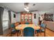 Dining room with wooden table, teal chairs, lighted ceiling fan and china cabinet at 36912 Skycrest Blvd, Fruitland Park, FL 34731